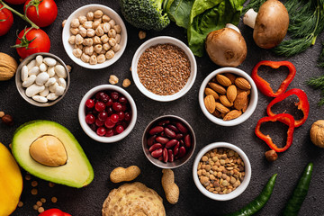 Vegan and healthy eating concept. Cereals and vegetables on a black background. Top view.