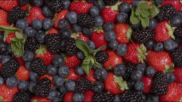 fresh ripe summer berries strawberries, blackberries, blueberries and mint rotate