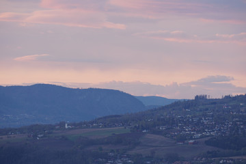 Landscape with city suburbs after sunset.