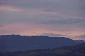Landscape with city suburbs after sunset.