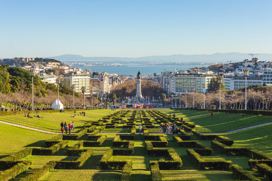 View of Parque Eduardo VII in Lisbon, Portugal, on a beautiful winter sunny day, with castle on the left and the Tejo river and Arrabida mountains in background