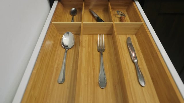 One piece of types of cutlery in the drawer of the kitchen cabined as a minimalist organizing system