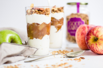 Apple parfait with yogurt and granola on a marble surface