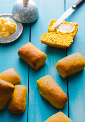 Carrot buns with butter on blue background