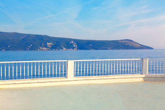 pedestrian walking at sea shore , white balustrade of seaside 