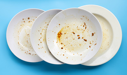 Dirty dishes on blue background.