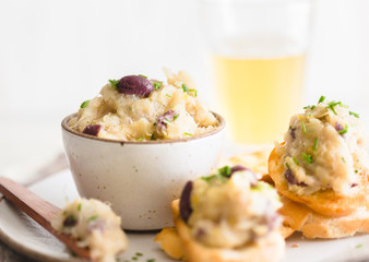 Cod fish brandade on a white ceramic and rustic napkin