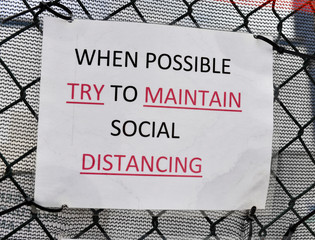 As the COVID-19 coronavirus pandemic grows, city officials place public messages and signs to advocate social distancing and to wear face masks to help prevent its spread