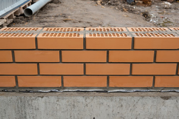 Double brick wall during fence construction work