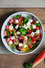 Summer salad with watermelon, tomatoes, feta cheese and basil