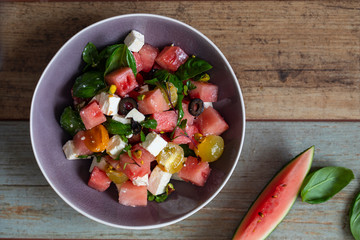Summer salad with watermelon, tomatoes, feta cheese and basil