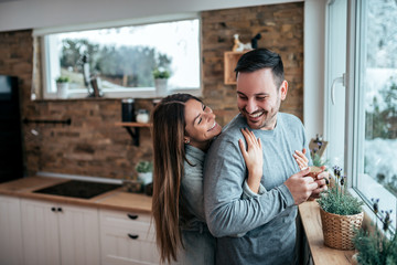 Portrait of a joyful young couple in the kitchen.