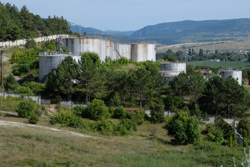 Fototapeta na wymiar Oil storage tanks at oil depot. reservoir vertical steel.