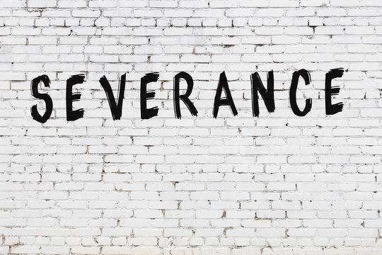 Word severance painted on white brick wall