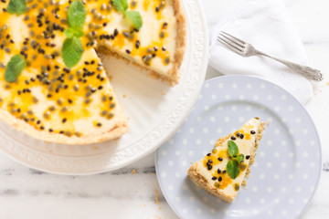 Paasion fruit cheesecake on a cute ceramic on a marble surface