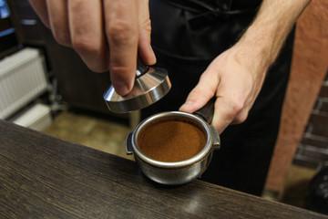barista holds a coffee horn
