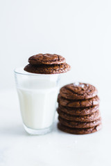 chocolate brownie cookie with glass of milk