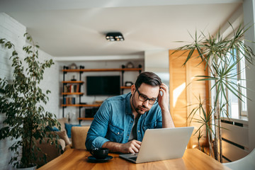 Portrait of a man with troubled face looking at laptop at home office.