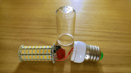 disassembled LED lamp similar to corn with a plastic protective glass.