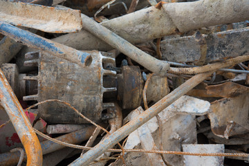 A pile of scrap metal close-up. Rusty metal parts. Variety of shapes and colors.