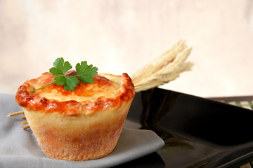baked pie stuffed with chicken, shrimp, meat on the table, isolated on blurred background. typical Brazilian food empadinha