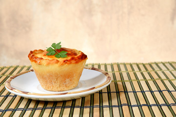 baked pie stuffed with chicken, shrimp, meat on the table, isolated on blurred background. typical Brazilian food empadinha
