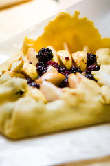 Pear and blackberry galette on a free form and parchment paper