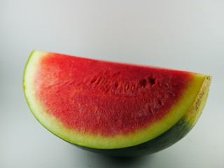 A quater of watermelon cut on the white background.