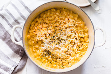 Pumpkin mac and cheese on a white background and rustic dish and napkin