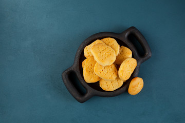 Gluten-free homemade cookies in a wooden plate on a blue background. Top view, copy space