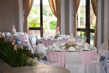 Table served in city hotel, birthday celebration, patisserie and themed decoration, interior with tables and tablecloth.