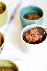 Chocolate mousse on tiny cups and marble background