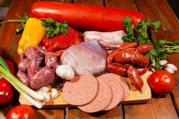 Raw meats on wooden table in kitchen to prepare nutritious dishes, food pyramid