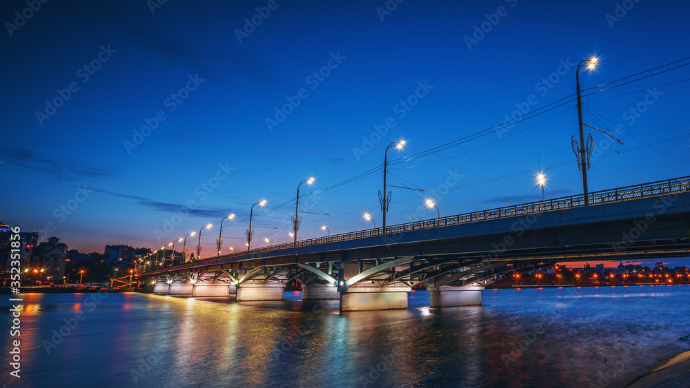 Wall mural beautiful panoramic view at illuminated voronezh city bridge in blue hour after sunset.