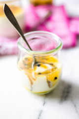 passion fruit panna cotta on tiny glasses and pink napkin