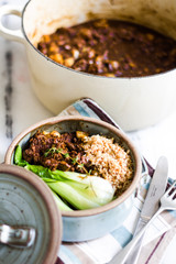Beef stew with bok choy on a marble surface