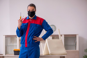 Young carpenter working indoors during pandemic disease