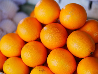 Tangerines in the market. Ripe fruit for vegetarians. Vitamins and natural food.