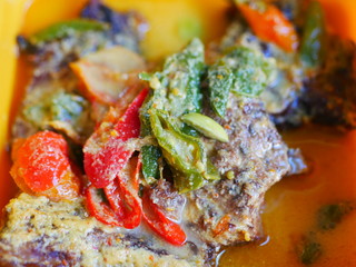 Mangut pe fish on box. It is traditional food from indonesia made from smoke fish.This fish is cooked back with coconut milk sauce and various seasonings. The taste tasty, sweet and spicy.