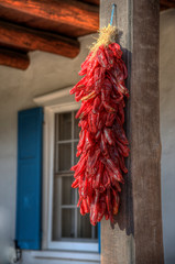  Red Chile Ristra String Hanging in Front of Blue Shutters