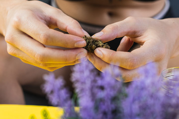 Anonymous woman holding a CBD cannabis flower