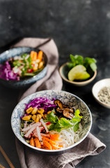 Homemade rice noodles salad with radish, carrot, red cabbage cilantro