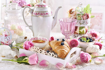 Fototapeta na wymiar romantic breakfast with croissant and blueberries on white tray
