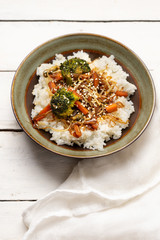 Thai style rice with fried vegetables and soy sauce on white background