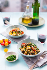 Homemade  salad with chickpea, roast beef and cherry tomatoes with red wine on a acqua surface daylight