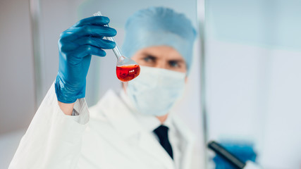 Fototapeta premium close up. medical flask in the hands of a laboratory assistant.