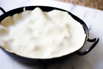 Tarte tatin being served on a white marble surface