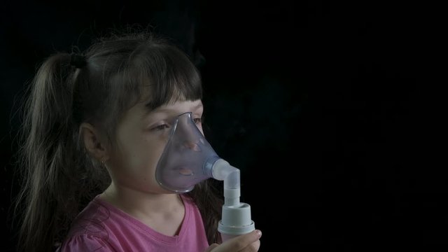 Cure child bronchitis. Little girl in a nebulizer mask.