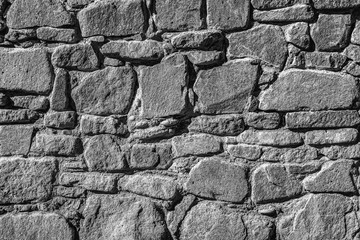 Stone wall as a background or texture. Black and white