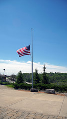 A large American flag at half mast  during Memorial day weekend flies over the Monon High Bridge Trail